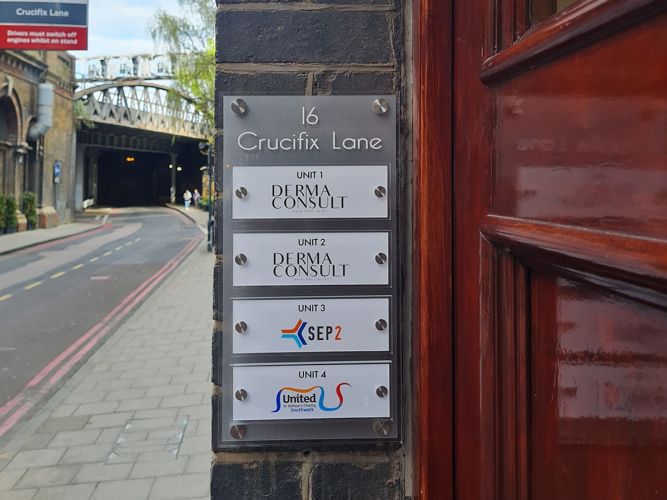 Acrylic building sign with adjustable panels